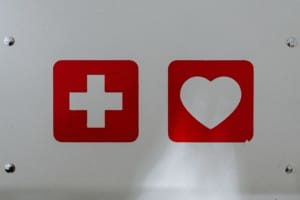 Safety a white wall with a white safety cross and white heart surrounded by red