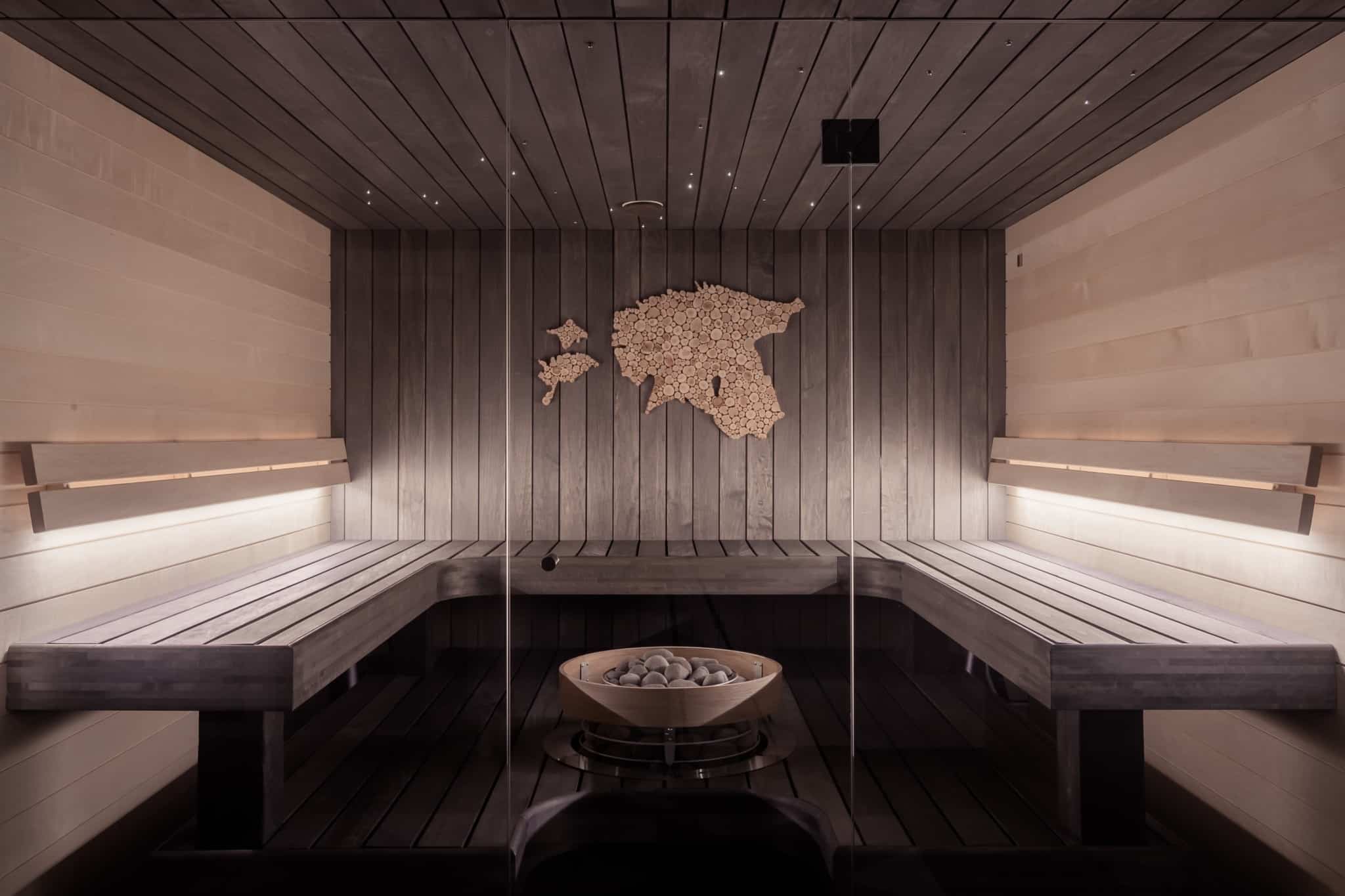 Inside of a wooden sauna with a world map on the wall