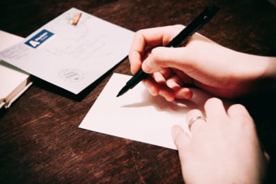 hand writing on paper a hand writing on a piece of paper