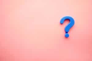 A blue question mark against a pink background